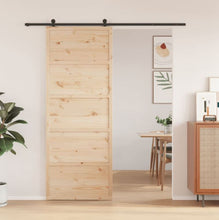 Load image into Gallery viewer, Wooden sliding door in a room with a dining table and decor