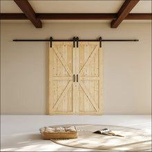 Load image into Gallery viewer, Wooden sliding barn door in a room with a white wall and wooden beams.
