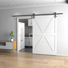 Load image into Gallery viewer, White barn door with black hardware in a modern interior setting.
