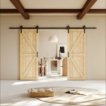 Load image into Gallery viewer, Wooden sliding barn doors in a modern interior setting with a table and lamp in the background.
